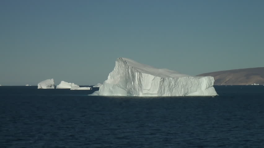 Beautiful  Iceberg close to northern Greenlands coast in the High Arctic. Calm and cloudless day. Some ice patches. Realtime. Smooth. 