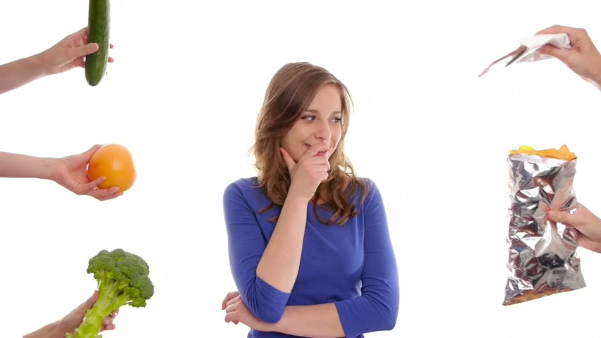 girl tries to decide to eat healthy vegetables or sweets and snacks