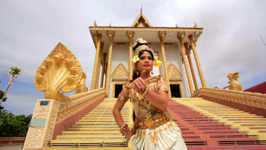 Apsara Dancer dancing near a temple in the afternoon