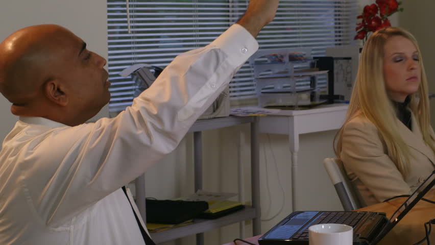 A projector shines a graph on the screen and on the businessman making the presentation. Canon C300