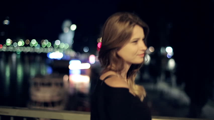 Young happy woman walking in the city, steadicam shot
