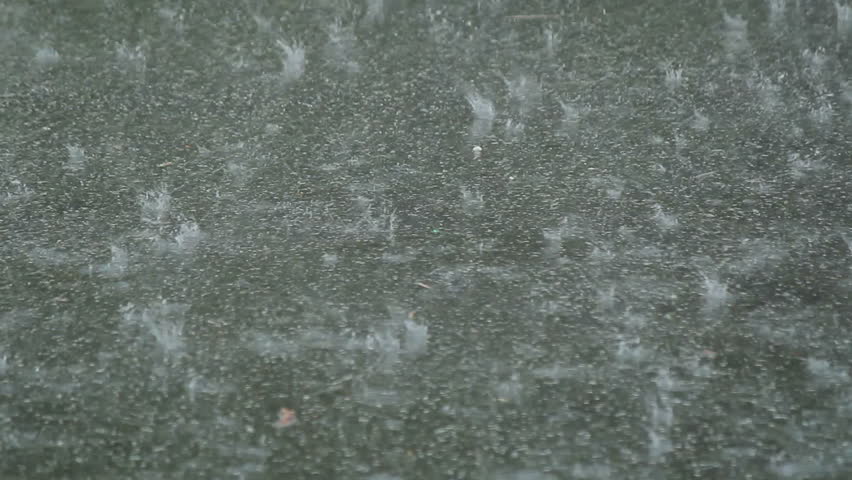 Very heavy rain falling on pavement
