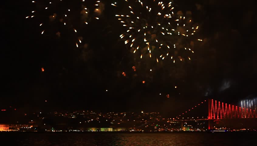 Amazing fireworks, full of fire, smoke and reflections in Istanbul, Turkey. View of the Ortakoy region and part of the Bosporus Bridge. 