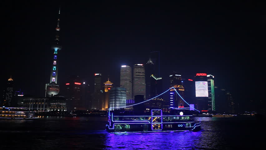 SHANGHAI, CHINA - MAY 10, 2012 Boats Traffic in front of Shanghai Skyline, China, Huangpu River, Skyscrapers, Cityscape, Ships