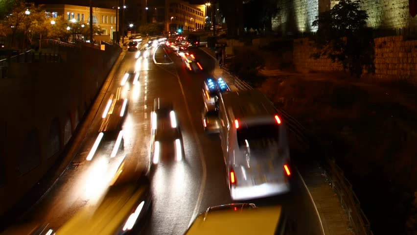 JERUSALEM, ISRAEL - NOVEMBER 01: Drivers, commuters and tourists hurry to their destinations during rush hour near the wall of Jerusalem, time lapse view, Israel, 01 November 2012