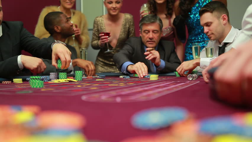 Men placing bets and waiting for dealer in the casino