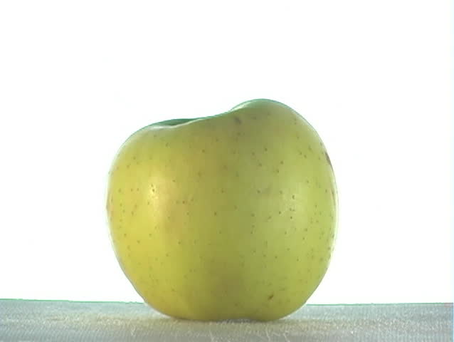 Green syrup pouring over an apple.  The syrup could be apple flavor, mint flavor, or ???