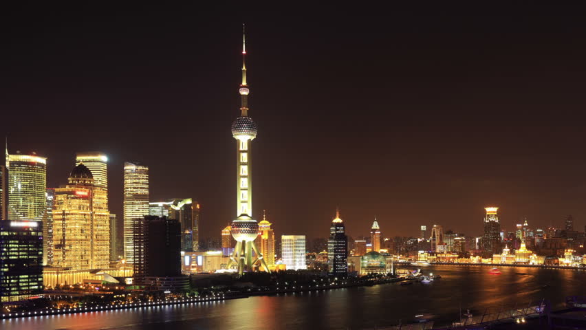 Shanghai night, zoom out timelapse. Shanghai skyscrapers and Huangpu river, China. On the left, Pudong with the Oriental Pearl Tower. On the right, The Bund (Puxi Waitan).