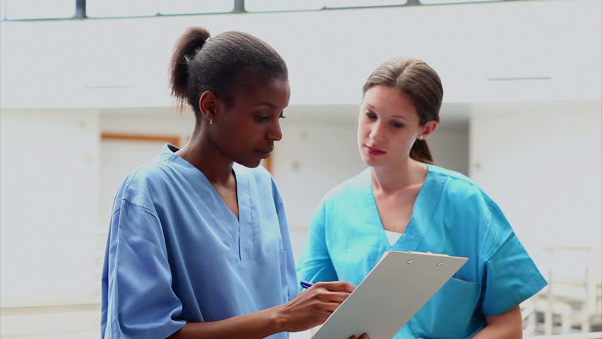 Nurses looking at a medical chart in hospital