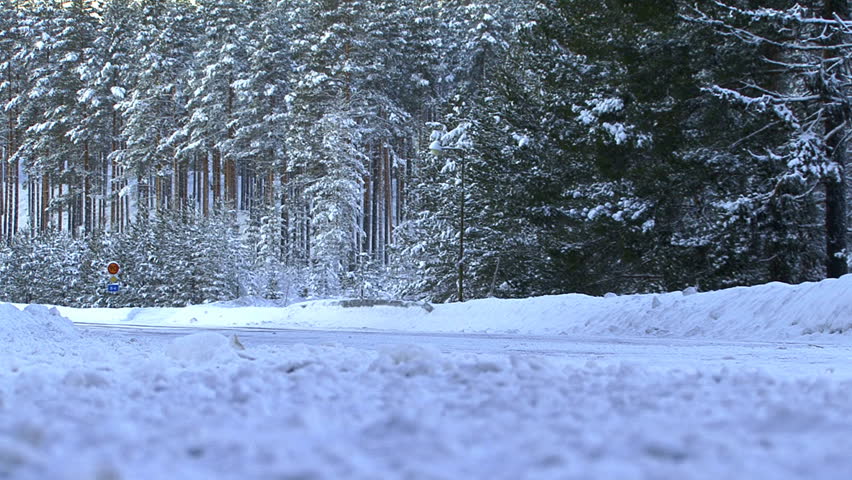 Truck driving on country road in the snow, Sweden