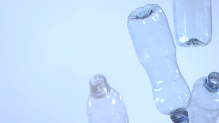 Empty bottles falling in super slow motion in studio