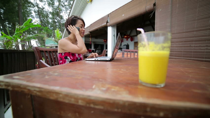 Freelance business woman working at cafe, closeup of juice
