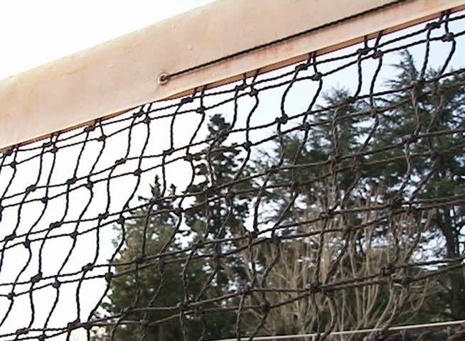 Tennis ball passing over the net. Slow Motion.