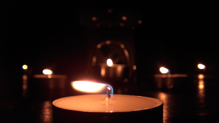 Beautiful candle lights in pitch black night 