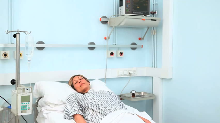 Doctor writing on his chart in hospital ward