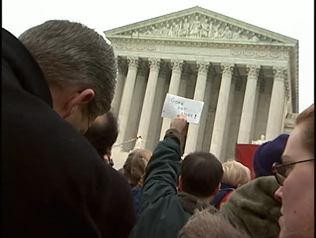 WASHINGTON, DC - DEC 11: Supporters of Al Gore for President at the US Supreme Court on December 11, 2000, while the justices inside hear oral arguments in Bush v Gore. Zoom to 'Gore Got More' sign