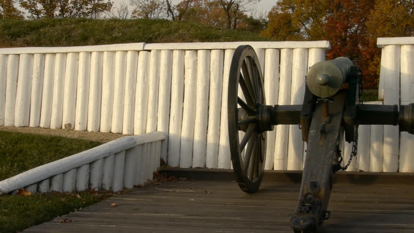 Panning shot of parapet and embrasure with 24 pounder smoothbore howitzer gun in historic Civil War site of fort Ward in Alexandria Virginia HD 1080p