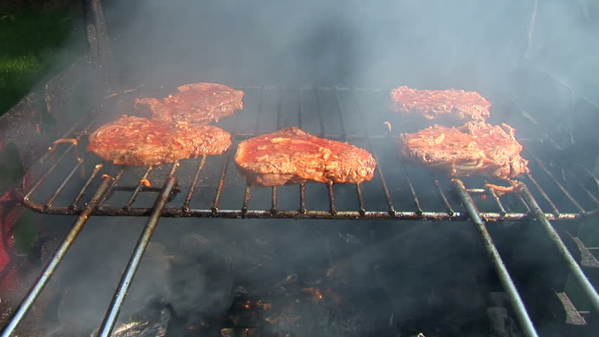Beef stake barbecue cooked outdoors, close-up, smoke and nature
