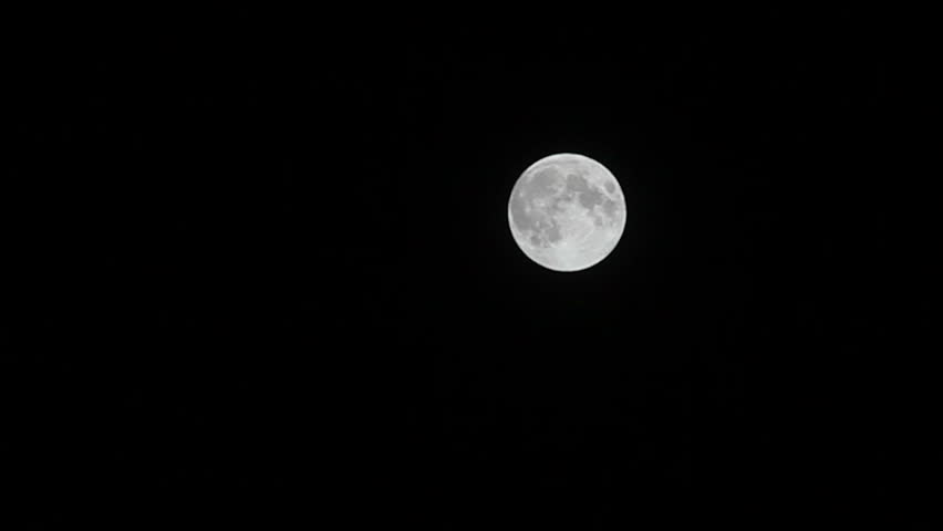 Full moon with relief spots on the black sky.