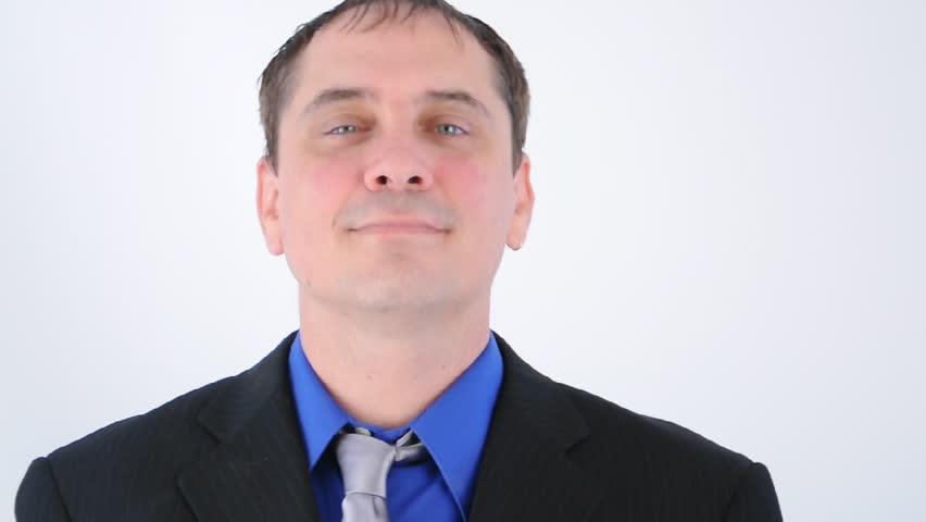A business man is nodding his head for approval and is happy about something on a white isolated background.