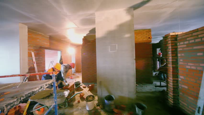 MOSCOW - OCTOBER 7: Workers build walls in room at construction site of residential complex Elk Island on October 7, 2011 in Moscow, Russia. Complex includes 1334 apartments of 40-143 square meters