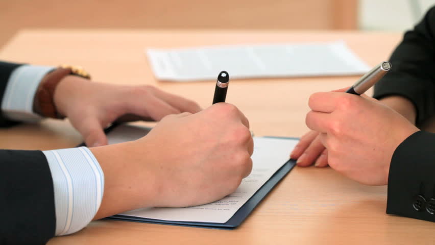 Business people signing the contract marking the beginning of their partnership