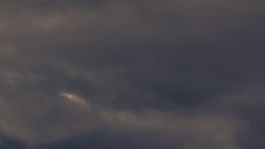 Dark, brooding cloudlapse. An opening in the sky as clouds move by. Dark to light.