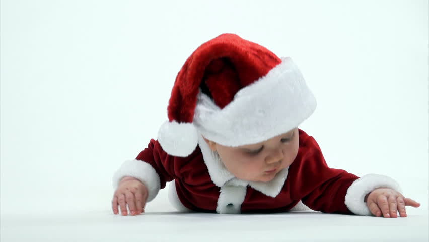 Cute 7-month-old baby boy in red Santa Claus outfit on white background