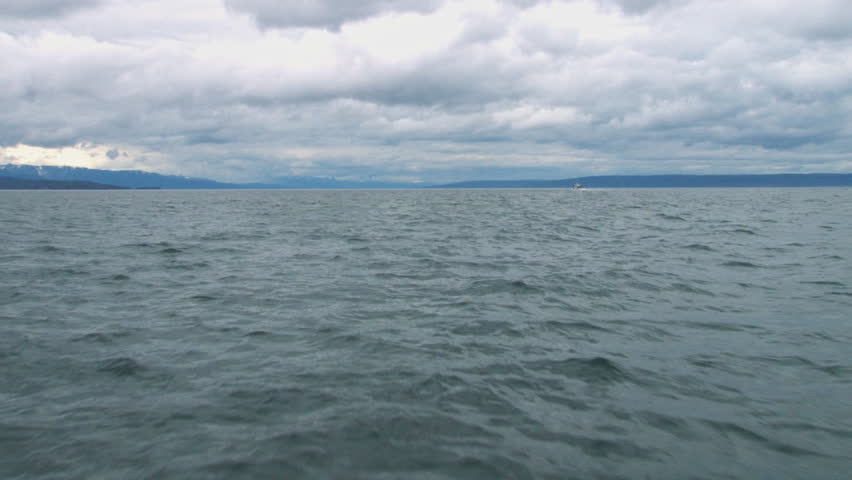 POV of passing over waves. Camera position a few feet above the water at the boat's bow.