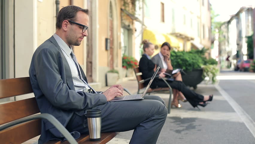 Successful businessman with laptop in the city
