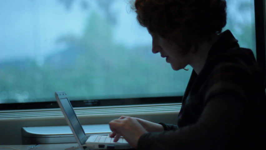 Woman using laptop in train