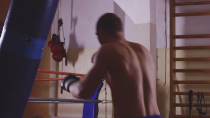 Young boxer trains on punching bag