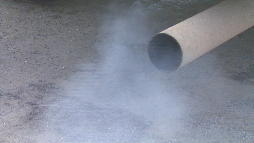 Exhaust emissions from a gasoline internal combustion engine spews from the truck's tailpipe.