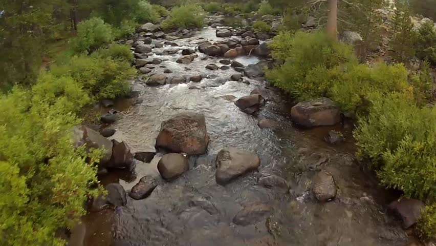 Small River Flyover - Low level aerial flyover of a small mountain river in the California Sierra Nevada mountains on an overcast Autumn day.