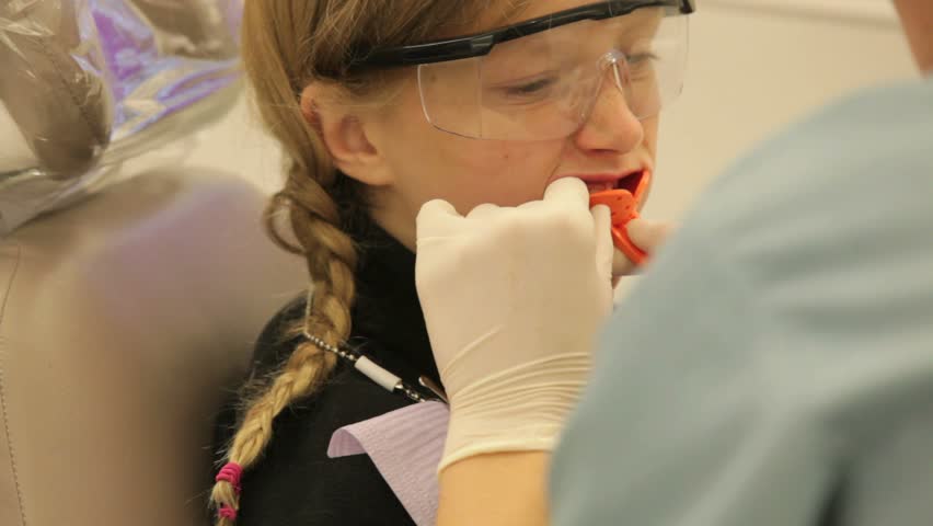 Girl having teeth impressions taken