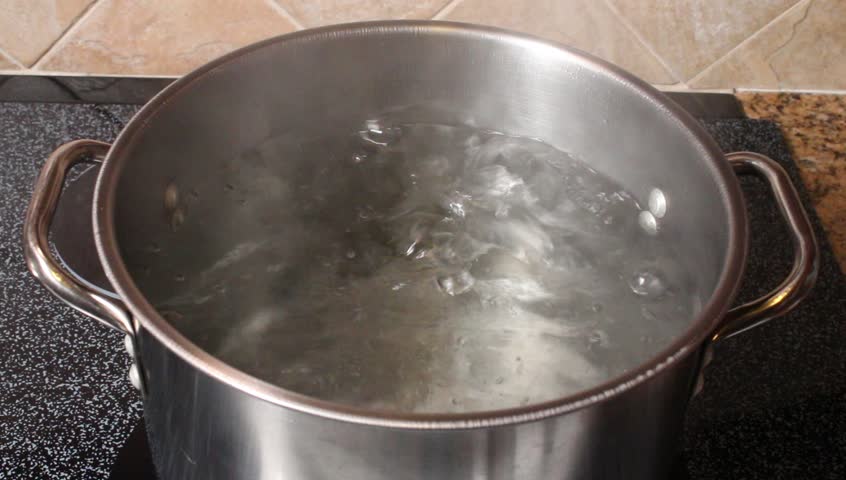 Boiling water in a kitchen pot as a symbol of cooking or food preparation and sterilization of contaminated tap water for healthy pure drinking liquid.