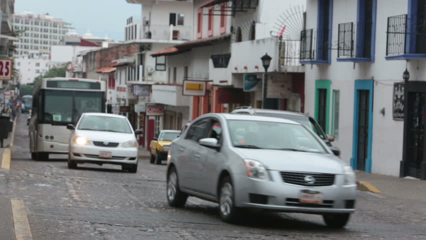 PUERTO VALLARTA MEXICO NOV 2012: Economy improves more tourists travel to Mexico. Local businesses starting to revive with tourism and local jobs. Puerto Vallarta main street busy traffic soft focus. 