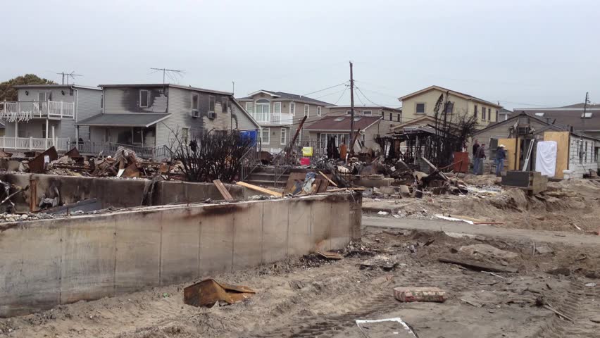 BREEZY POINT, QUEENS, NY-December 2, 2012: Video clip of wreckage and debris from homes destroyed by devastating fire during Hurricane Sandy.  End of clip reveals people carrying recoverable items.