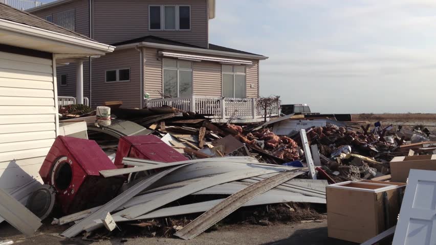 BREEZY POINT, QUEENS, NY-December 2, 2012: Footage clip of homes destroyed by waves and storm surge from Hurricane Sandy. Video pans across wreckage of destroyed homes, ends with image of U.S. Flag