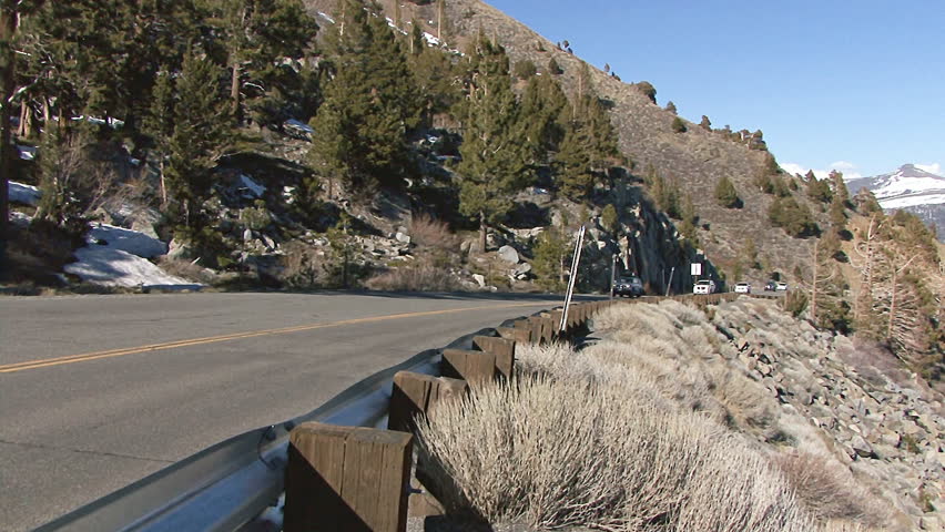 HIGH SIERRAS, CA - CIRCA 2012: Passenger cars and trucks file up and down the highway over Monitor Pass in the Sierra Nevada in spring time.