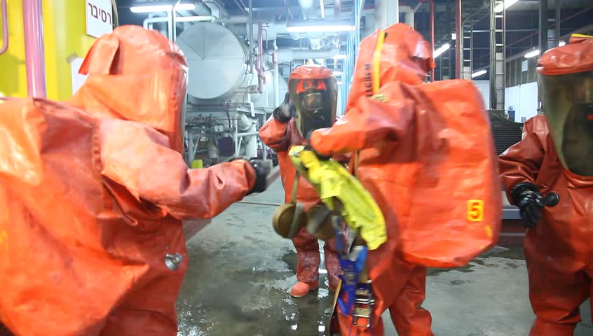 NORTHERN ISRAEL -DECEMBER 17: Firefighters practice to remedy leak accident of corrosive toxic hazardous material Ammonia liquid in seven food factories using protective suites, Northern Israel December 17 2012