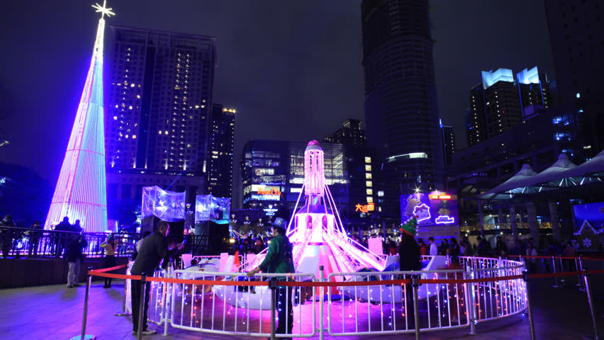 NEW TAIPEI CITY, TAIWAN - CIRCA DECEMBER 17,2012: (Time lapse) People gathering together at The Civic Plaza of New Taipei City and enjoy the amusement airplane rides just before the Christmas.
