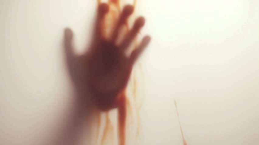 Blood-smeared hand - probably of a crime victim - behind frosted glass