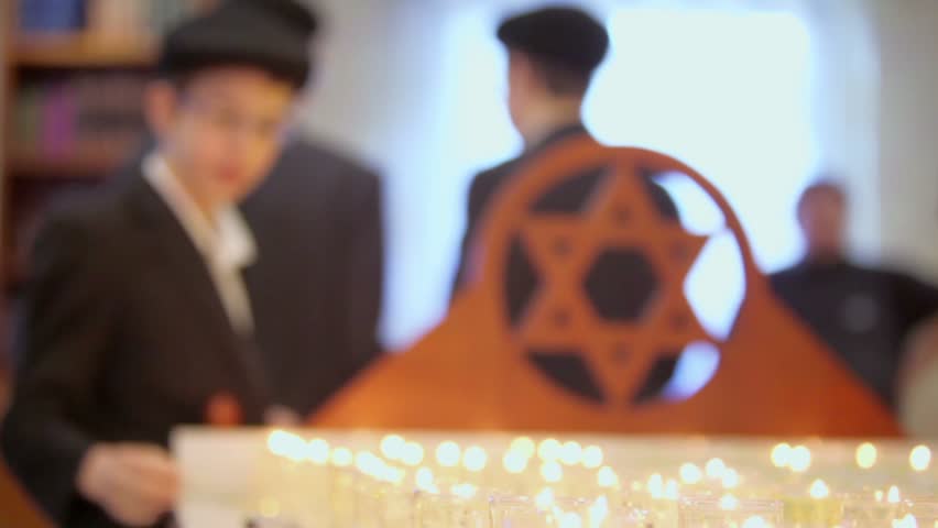 MOSCOW - JAN 27: Young jewish boys near funeral candles and wooden merkaba in Moscow synagogue Beis Menachem in International Holocaust Remembrance Day, on Jan 27, 2012, Moscow, Russia.