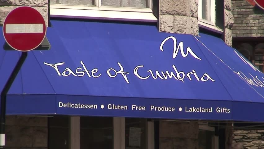 LAKE DISTRICT, CUMBRIA, UNITED KINGDOM - CIRCA 2010: Zoom out of a delicatessen on a street corner in Windermere.