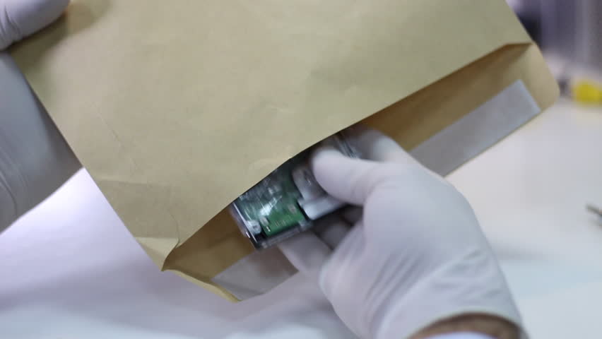 Technician wrapping hard drives for shipment    