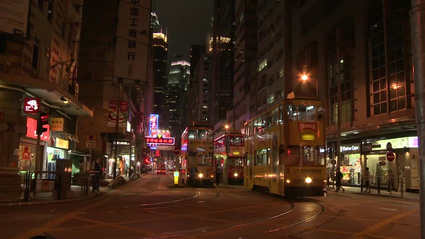 HONK KONG,CHINA - CIRCA AUG 2011: Timelapse of trams leaving trams stop at night in Sheung Wan, Hong Kong, China. August 2011. 