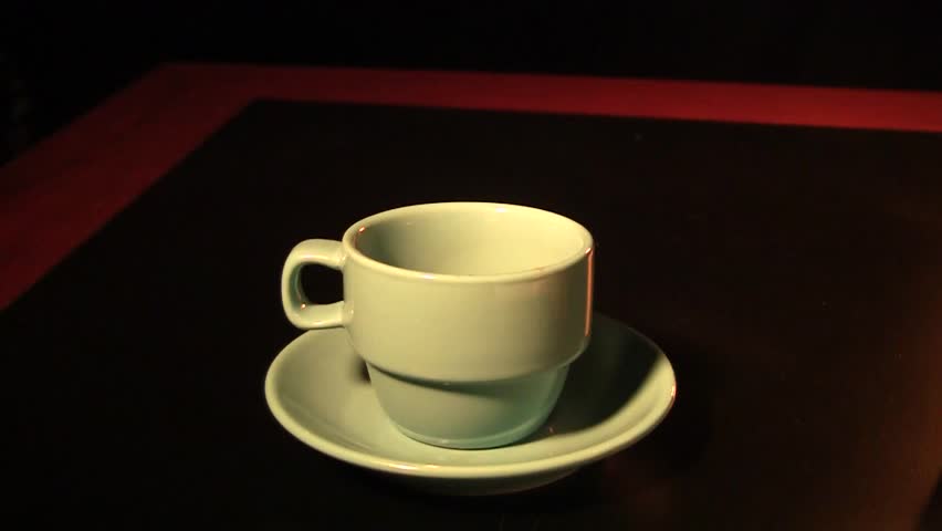 pouring a cup of hot espresso coffee