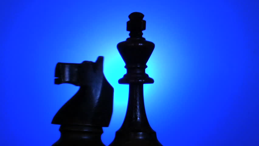 chess king and knight in silhouette, rotating