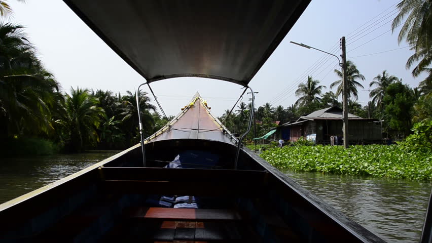 Thailand, Amphawa. View of typical waterfront homes along the Amphawa waterway from fast traditional longtail boat. (UR)